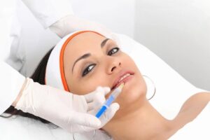 29910532 - young woman having lip augmentation at beauty clinic