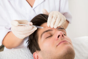 44702571 - young man having botox treatment at beauty clinic