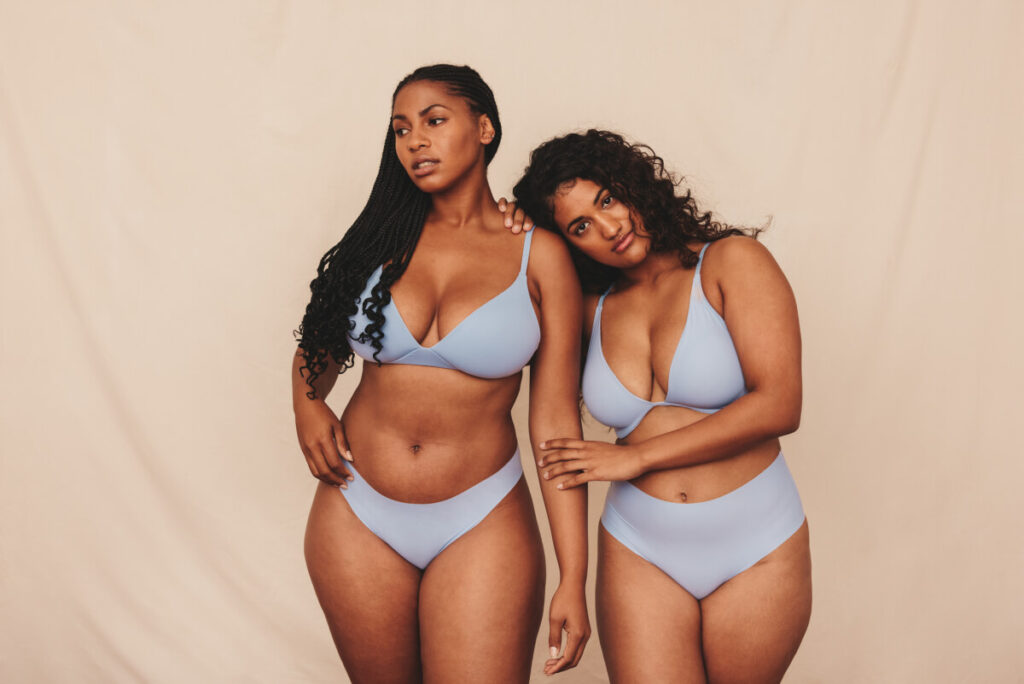 Two young women embracing their natural bodies and curves