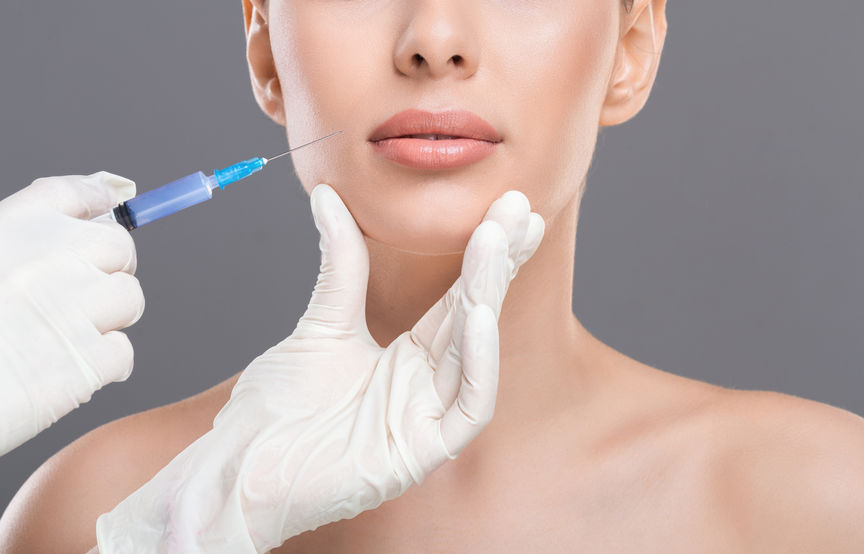 woman receiving cheek filler injection